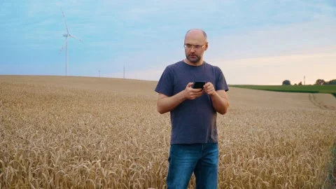 Caucasian man using and tapping on smartphone making online purchases while Stock Footage 209616960