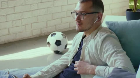 Caucasian man using cellphone and wireless earphones listen to music while Stock Footage 172227169
