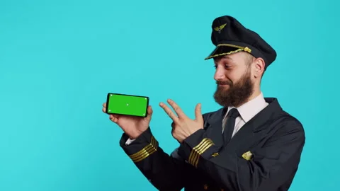 Caucasian man using greenscreen dressed as pilot Stock Footage 233644362
