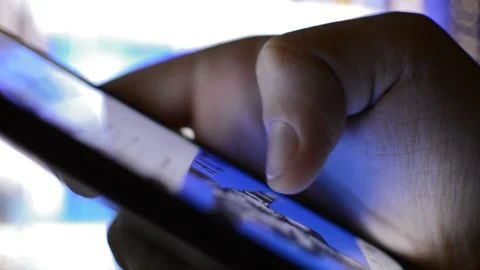 Caucasian man using iphone in a night city background. iphone communication. Vídeo Stock 221253380