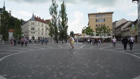 Caucasian man using old exercise bike in the middle of the town square. Stock Footage 121175836