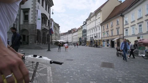 Caucasian man using old exercise bike in the middle of the town square. Stock Footage 121462363