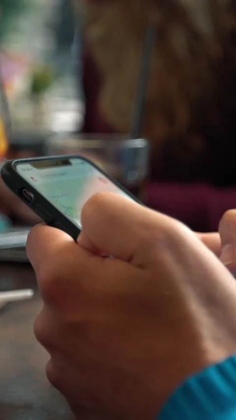 Caucasian man using a smartphone in bar with sparkling aperol cocktail 스톡 동영상 317261057