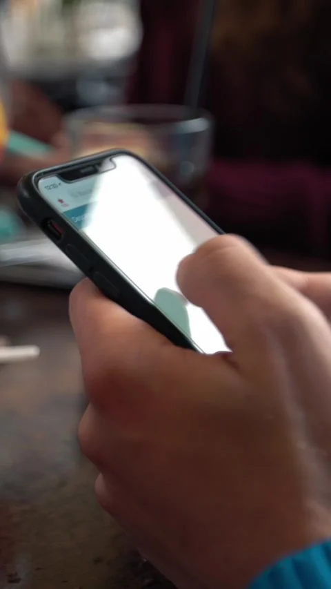 Caucasian man using a smartphone in bar with sparkling aperol cocktail Stock Footage 318742979
