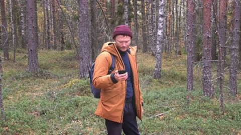 Caucasian man using smartphone to find his location in the forest. Traveler Stock Footage 163032870