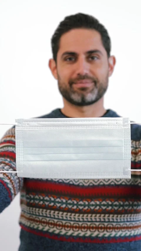 Caucasian man using sterile face mask isolated on white background studio. Stock Footage 328020113