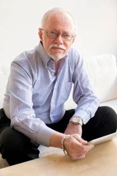 Caucasian man using tablet computer on sofa 스톡 사진