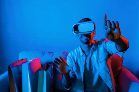 Caucasian man with vr glass choosing program while sitting at sofa. Deviation. 스톡 사진