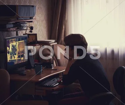 Caucasian Man Watching Computer Screen At Desk