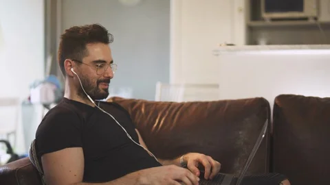 Caucasian man working from home with computer, work inside, during covid-19 動画素材 129866321