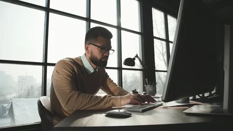 Caucasian man is working on laptop computer at style loft office. Stock Footage 87967868