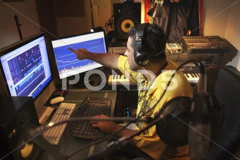 Caucasian man working in music studio Stock Photos