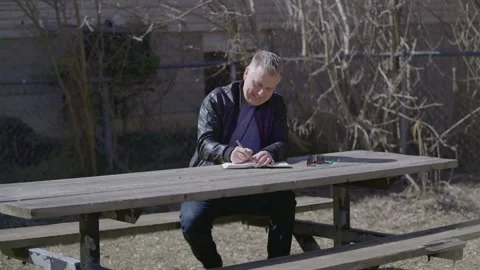 Caucasian Man Writes Outside Stock Footage 150459661