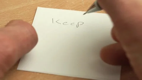 Caucasian man writing a note with Keep Going text Stock Footage 322114559