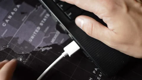 Caucasian man's hand plugging white cablo on the laptop's hardware. Stock Footage 213250221