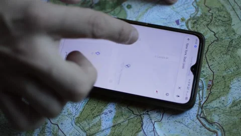 Caucasian man's hand using google digital gps on a trekking map. Video stock 218472207
