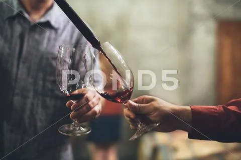 Caucasian men tasting wine in cellar Stock Photos