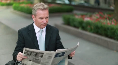 Caucasian middle aged businessman reading newspaper Stock Footage