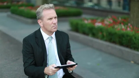 Caucasian middle aged businessman using tablet pc in New York City Stock Footage 32354713