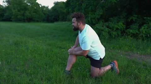 Caucasian millennial runner experiencing knee pain during outdoor workout Stock Footage 295944821