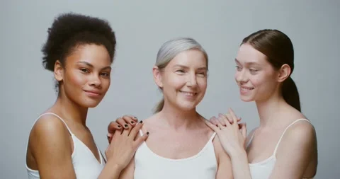 Caucasian models with large age differences stand beside African-American woman Stock Footage 168059963
