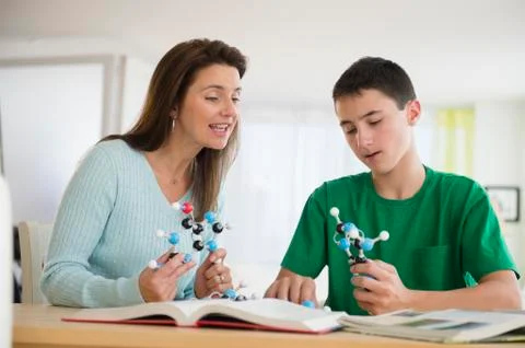 Caucasian mother and son studying atom models Stock Photos