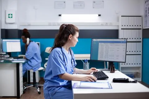 Caucasian nurse writing appointment data Stock Photos