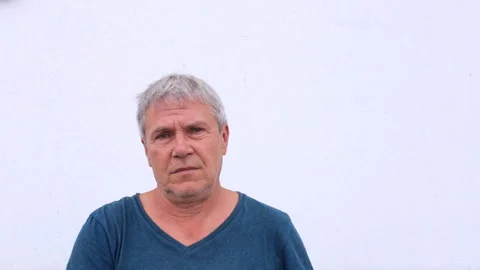 Caucasian old gray-haired man with pain in his eyes takes off his glasses and Video stock 220083130