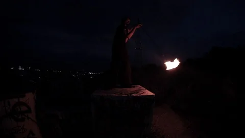 Caucasian performer dancing outside with fire making show with night city lights 스톡 동영상 114271851