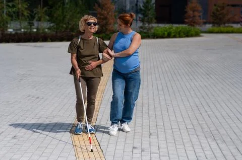 Blind person woman in sunglasses and walking cane Vector Image
