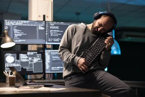 Caucasian programmer pretending to play keyboard like guitar Stock-Fotos