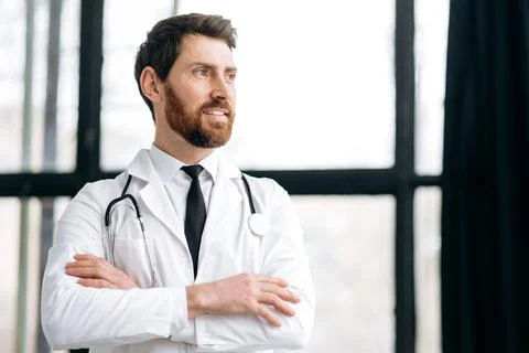 Caucasian proud handsome male doctor, therapist, surgeon, cardiologist in a Stock Photos