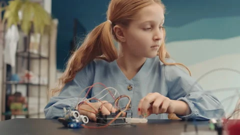 Caucasian Schoolgirl Constructing Robot Video stock 153463588