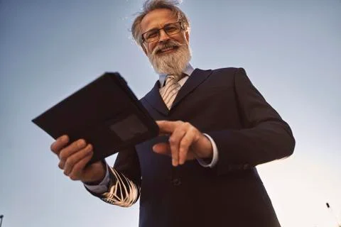Caucasian senior CEO using a smart tablet Stock Photos