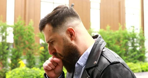 Caucasian sick bearded man caught  walking down the street. Stock Footage 221896541