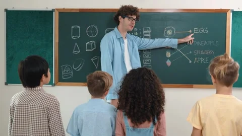 Caucasian smart teacher teach while student standing at blackboard. Pedagogy. Stock Footage 275618361