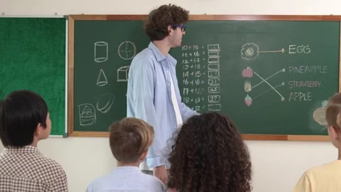Caucasian smart teacher teach while student standing at blackboard. Pedagogy. Stock Footage 282455749