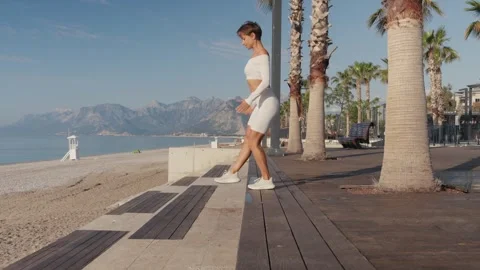 Caucasian sportswoman training using bench, doing exercises for legs. People Video stock 243722016