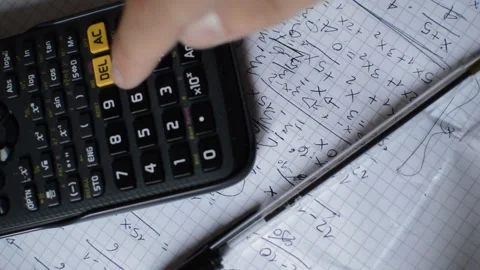 Caucasian student doing math assignment with pen and calculator. Stock Footage 213263327