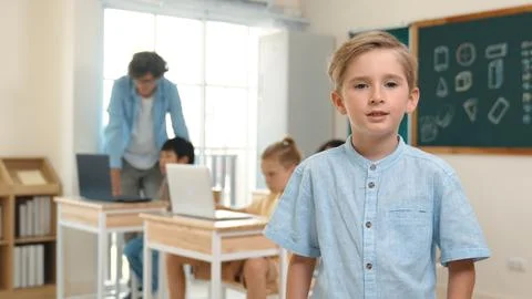 Caucasian student looking at camera while friend studying about code. Pedagogy. Foto stock