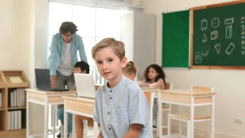 Caucasian student looking at camera while friend studying about code. Pedagogy. Foto stock