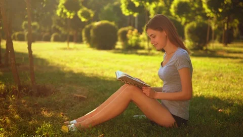 Caucasian student resting in park Stock Footage 127860064