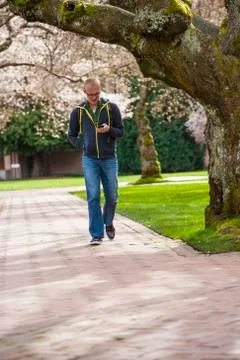 Caucasian student using cell phone on campus 写真素材