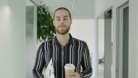 Caucasian Successful Manager Going Through the Workspace Holding Coffee and Stock Footage 249883441