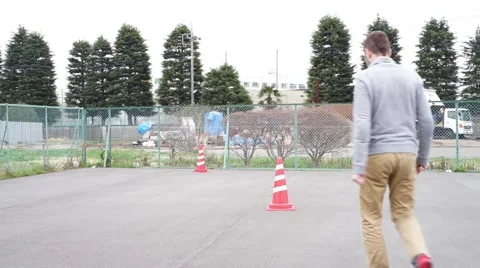 Caucasian super human man flies into the sky from parking lot in Tokyo Japan Stock Footage 52202425