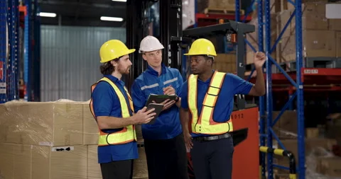 Caucasian supervisor using tablet while african american worker explaining Stock Footage 321803314