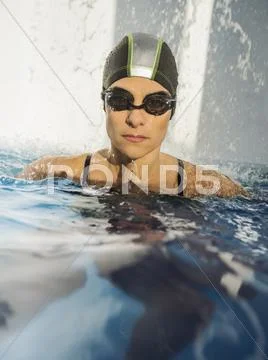 Caucasian Swimmer With Swimming Cap In Swimming Pool