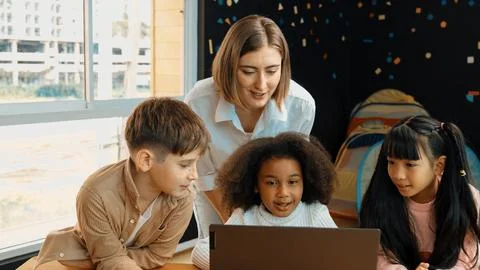 Caucasian teacher checking student answer while learner using laptop. Erudition. Stock Photos
