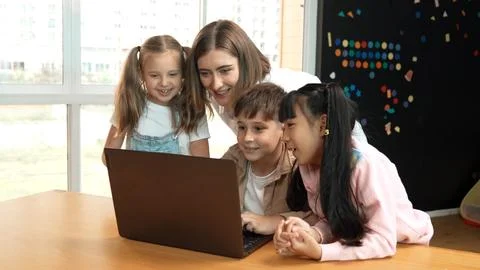 Caucasian teacher checking student answer while learner using laptop. Erudition. Stock Photos