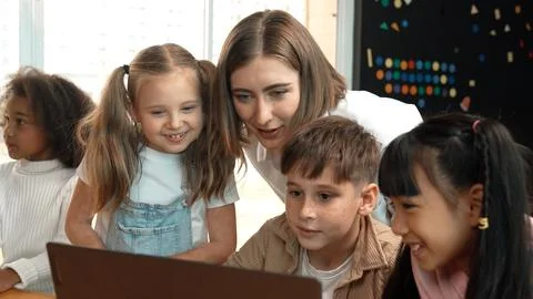 Caucasian teacher checking student answer while learner using laptop. Erudition. Foto stock